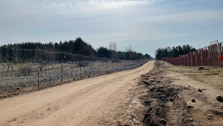 Poland builds a border wall, even as it welcomes Ukrainian refugees